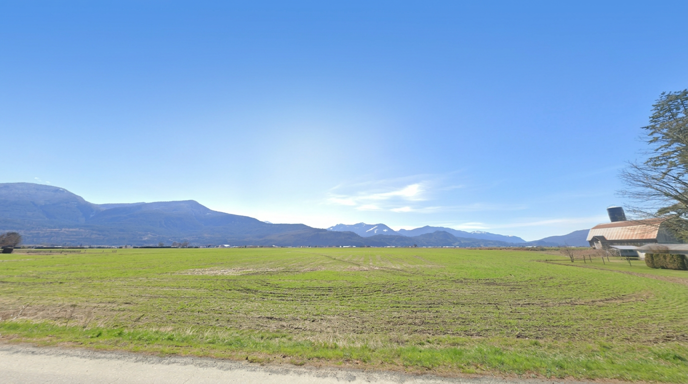 Farm fields beneath the mountains in Chilliwack, British Columbia